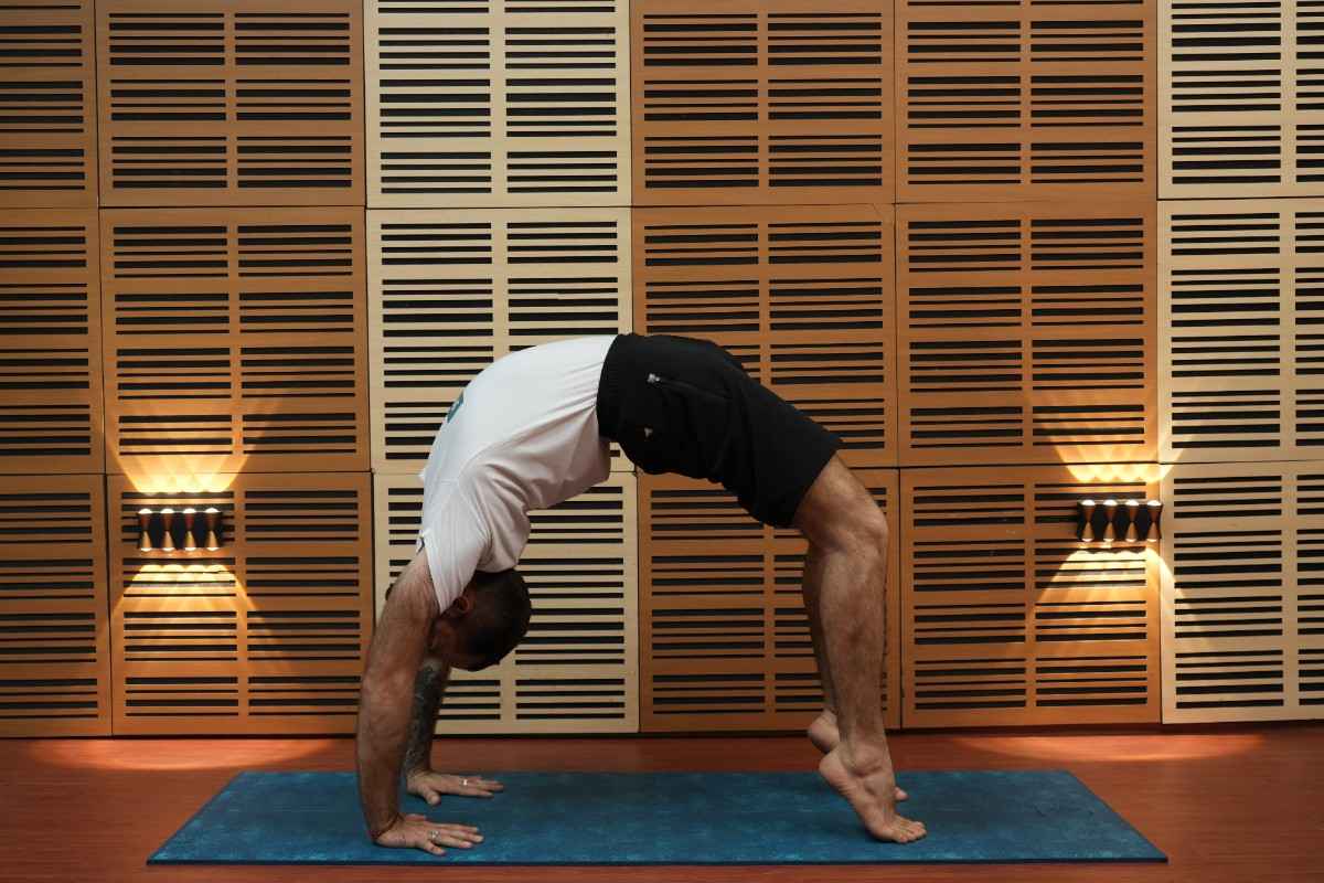 Yoga instructor performing wheel pose during a yoga practice session